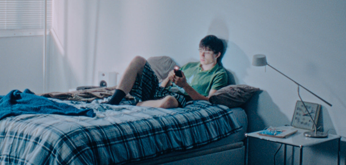 Person on a bed looking at a phone